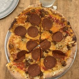 Vegan pizza with vegan pepperoni and vegan cheese. Vegan pizza with vegan pepperoni and vegan cheese.