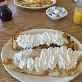 Swedish Pancake House - The three crepe breakfast in the foreground, the crepes, eggs and sausage in the background - New American Near Me - Rockford, Illinois Swedish Pancake House - The three crepe breakfast in the foreground, the crepes, eggs and sausage in the background - New American Near Me - Rockford, Illinois