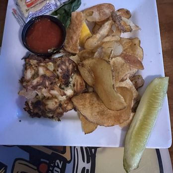 Woody's Dewey Beach - Crab cake sandwich (without bun) and chips. The crab cake was dry tonight. We left some on the plate. The chips lacked flavor. - American Near Me - Dewey Beach, Delaware Woody's Dewey Beach - Crab cake sandwich (without bun) and chips. The crab cake was dry tonight. We left some on the plate. The chips lacked flavor. - American Near Me - Dewey Beach, Delaware