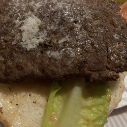 Wendy's - Horribly BURNT ice cold in middle like it just came out of refrigerator. No idea what the white crap on the patty is.