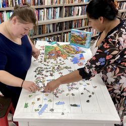 The Green Read - Try out the sample puzzle on one of the tables.  There's a great selection of new and used puzzles for sale.