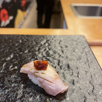 Kinzan Omakase - a person in the background - Sushi Bars Near Me - New York, New York Kinzan Omakase - a person in the background - Sushi Bars Near Me - New York, New York