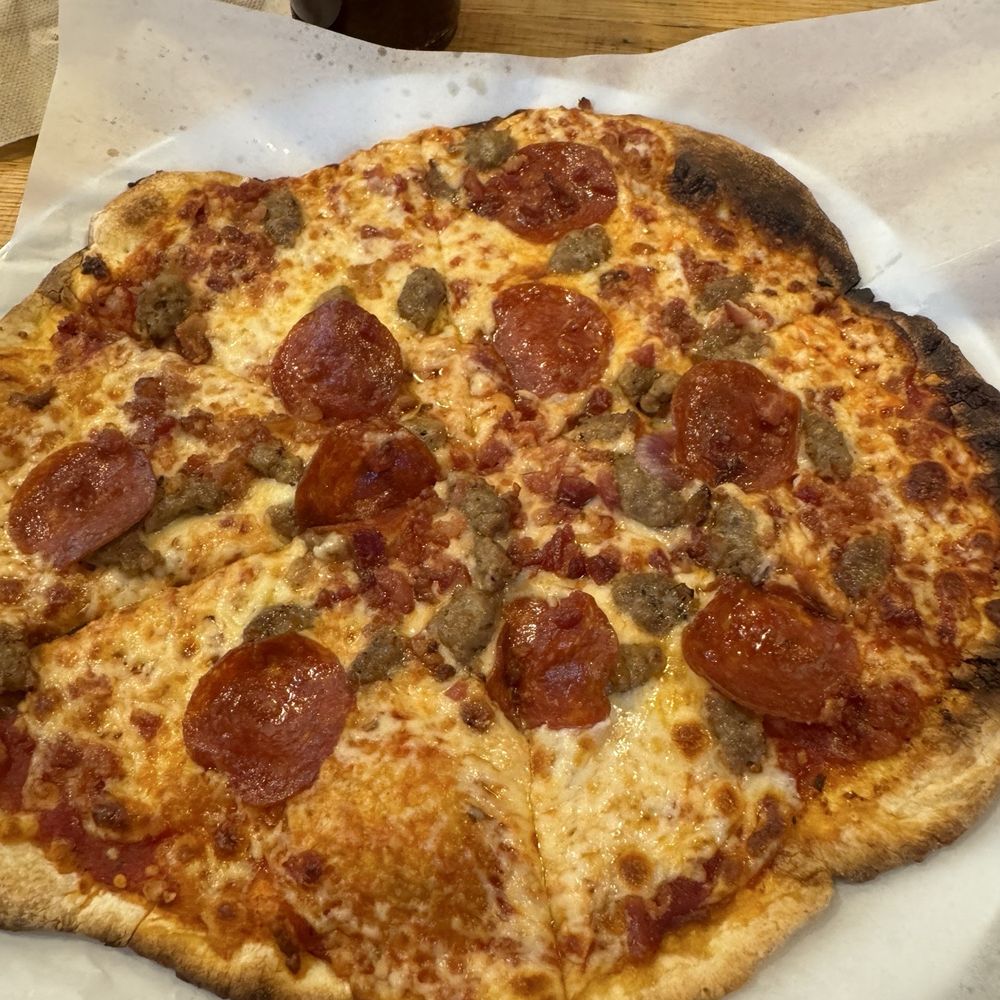 Pepperoni, sausage, and bacon with mozzarella and Parmesan cheese Pepperoni, sausage, and bacon with mozzarella and Parmesan cheese