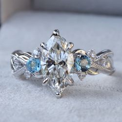 Custom Engagement Ring with marquise diamond and birthstones.