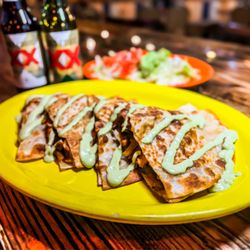 El Cazador Mexican Grill - Quesadilla Fajita. Filled with grilled steak or chicken, grilled veggies ( onions, green peppers, tomatoes) served with a guacamole salad.