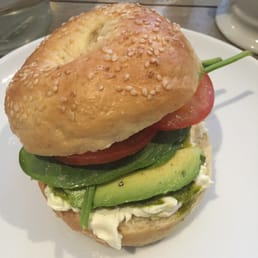Brunch bagel with avocado, mozzarella, spinach, tomato and pesto. Brunch bagel with avocado, mozzarella, spinach, tomato and pesto.