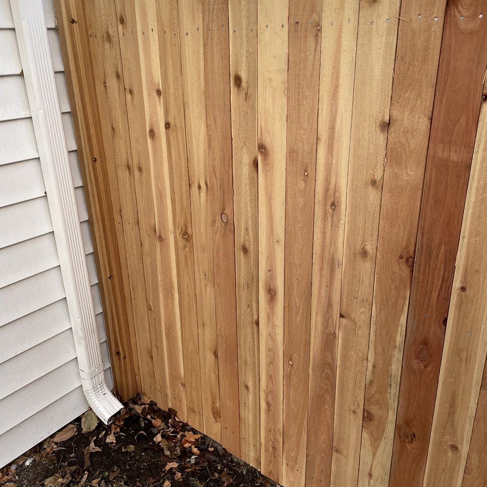 Denver Remodels - a wooden fence with a white pipe sticking out of it - General Contractors Near Me Denver Remodels - a wooden fence with a white pipe sticking out of it - General Contractors Near Me