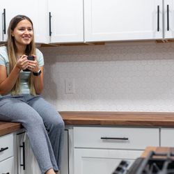 N-Hance of Charleston - Woman admiring kitchen after cabinet painting in Mount Pleasant