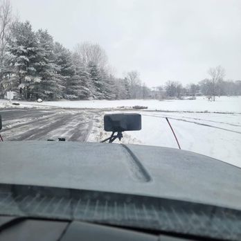 Edges Landscaping - a view of a snow covered road from inside a vehicle - Lawn Services Near Me