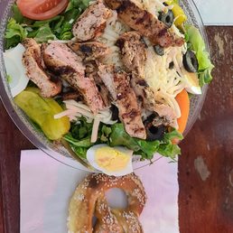 Grilled chicken salad, with house creamy parmesan, and a pretzel. Grilled chicken salad, with house creamy parmesan, and a pretzel.