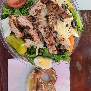 Schottzie's Bar & Grill - Grilled chicken salad, with house creamy parmesan, and a pretzel. - Salad Near Me - Saint Louis, Missouri Schottzie's Bar & Grill - Grilled chicken salad, with house creamy parmesan, and a pretzel. - Salad Near Me - Saint Louis, Missouri