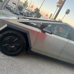My son sitting in his dream car