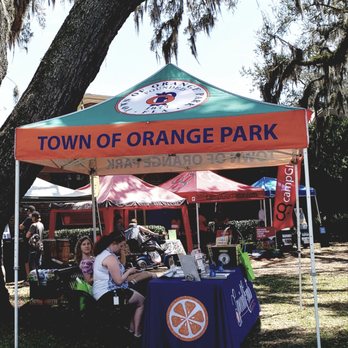 Orange Park - people sitting at a table under a tent - Farmers Market Near Me - Orange Park, Florida