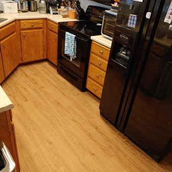 L&E Hardwood Flooring - a kitchen with black appliances - Flooring Near Me