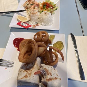 Stinger Ray's Tropical Bar & Grill - Turkey pesto wrap w onion rings & garlic shrimp. - American Near Me - Kahului, Hawaii Stinger Ray's Tropical Bar & Grill - Turkey pesto wrap w onion rings & garlic shrimp. - American Near Me - Kahului, Hawaii