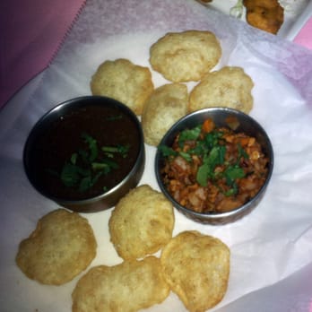 Indian Kitchen & Grill - Puris served with mint seasoned water along with chopped potato, lentil and chickpeas. - Indian Near Me - Madison, New Jersey Indian Kitchen & Grill - Puris served with mint seasoned water along with chopped potato, lentil and chickpeas. - Indian Near Me - Madison, New Jersey