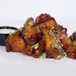 Bad Mutha Clucka - CHIPOTLE HONEY WINGS chipotle honey glazed chicken wings topped with cotija cheese & scallions; served with miso ranch