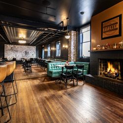 The Fitzroy - Wide angle of the fireplace featuring the Fitzroy logo