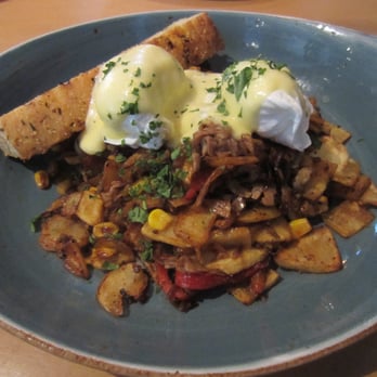 Milestones Restaurants - Prime Rib Hash: prime rib, potatoes, bell peppers, onions, roasted corn, two poached eggs, hollandaise sauce and a grilled foccaccia bread. - Canadian (New) Near Me - West Vancouver, British Columbia
