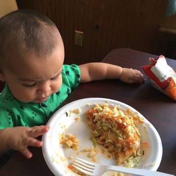 El Roble Restaurant Salvadoreño - a child eating a piece of pizza - Salvadoran Near Me - Reading, Pennsylvania
