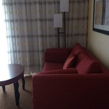 Courtyard by Marriott Melbourne West - The sofa is opposite the television. - Hotels Near Me - Melbourne, Florida Courtyard by Marriott Melbourne West - The sofa is opposite the television. - Hotels Near Me - Melbourne, Florida