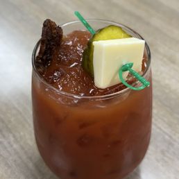 Spicy Bloody Mary with bacon, bread n butter pickle and a block of cheese.