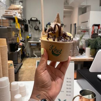 Peel Soft Serve - Coffe and banana base with bananas, peanut butter, coco bean chips, and chocolate drizzle - Food Trucks Near Me - Miami Shores, Florida Peel Soft Serve - Coffe and banana base with bananas, peanut butter, coco bean chips, and chocolate drizzle - Food Trucks Near Me - Miami Shores, Florida
