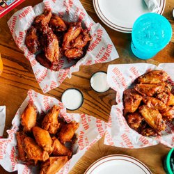 Hideaway Pizza - Wings - Choose between Buffalo, BBQ, NEW Mango Habanero, or NEW Garlic Parmesan. Served with ranch or blue cheese.