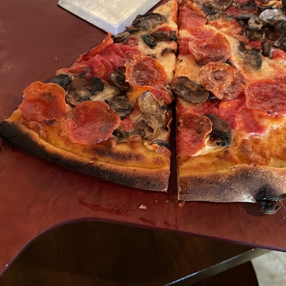 Anthony's Coal Fired Pizza & Wings - a half eaten pizza - Pizza Near Me - Monroeville, Pennsylvania