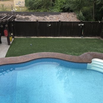 Empire Landscaping - an above ground pool with artificial grass - Landscaping Near Me