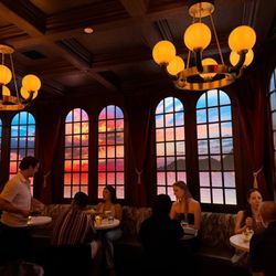 Captain's Quarters - Bench seating and tables by the sunset on the sea windows