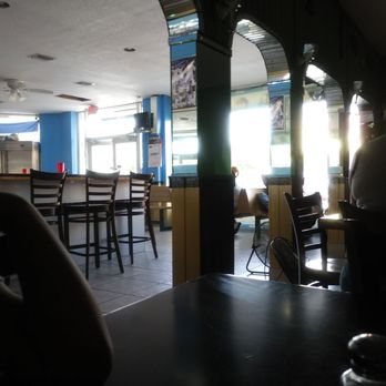 Tipicocentro Americano Cafe - a man sitting at a table - Cafes Near Me - Miami, Florida Tipicocentro Americano Cafe - a man sitting at a table - Cafes Near Me - Miami, Florida