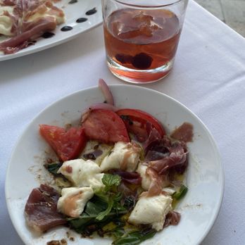 Olivia Restaurant & Rooftop - Capri salad with the mozzarella wrapped in prosciutto - Italian Near Me - Hollywood, Florida Olivia Restaurant & Rooftop - Capri salad with the mozzarella wrapped in prosciutto - Italian Near Me - Hollywood, Florida