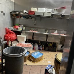 a commercial kitchen with a trash can a commercial kitchen with a trash can
