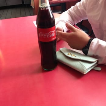 Cano's Mexican Restaurant - a man sitting at a table with a bottle of coke - Mexican Near Me - Los Angeles, California