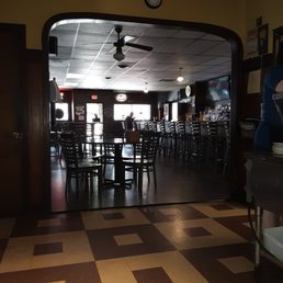 in dining room, looking through bar to the front door
