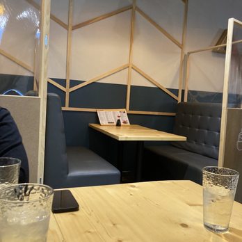 Sushi Sooshimi - a man sitting at a table in a restaurant - Japanese Near Me - Mississauga, Ontario