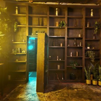 IZKINA - Entrance behind bookshelf - Lounges Near Me - Dallas, Texas IZKINA - Entrance behind bookshelf - Lounges Near Me - Dallas, Texas