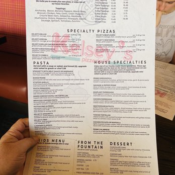 Kelsey's Pizza - a person holding a menu - Italian Near Me - Rockledge, Florida