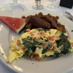 Omelette, potatoes, sausage, and watermelon wedge Omelette, potatoes, sausage, and watermelon wedge