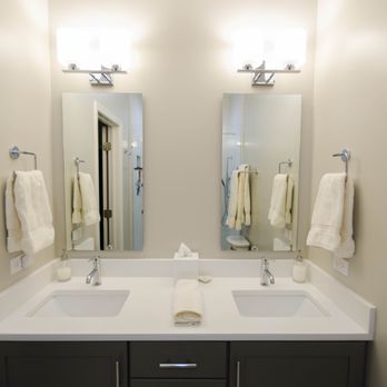 Eric Construction - a bathroom with two sinks and two mirrors - General Contractors Near Me