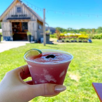 Nauti Spirits Distillery - a hand holding a glass of watermelon - Distilleries Near Me - Cape May, New Jersey