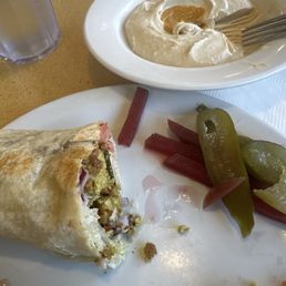 Half eaten Falafel Wrap and hummus