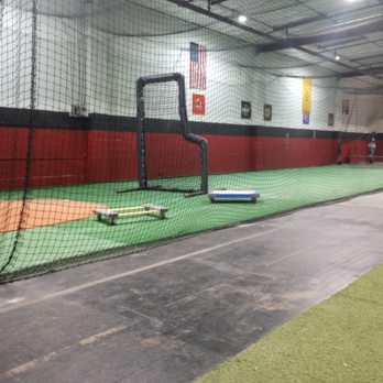 Lexian Renovations - a batting cage with a baseball and a baseball bat - General Contractors Near Me