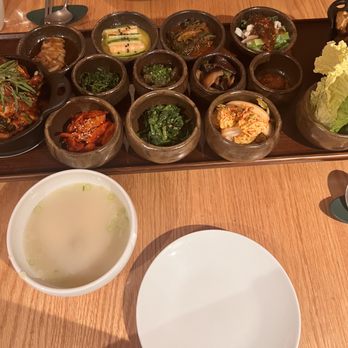 Moono - Stir-fried duck bulgogi (left), galbi-jjim (right), oxtail bone broth soup (bottom), side dishes (middle) - Korean Near Me - New York, New York