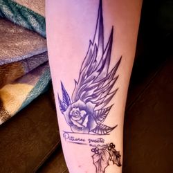 Freedom Tattoo - Rose, angel wing, holly leaves. To remember my mamaw. Done by bones. Did a wonderful job.