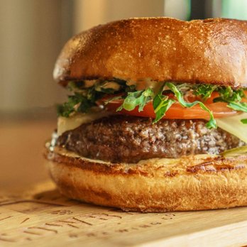 Cowbell Brewing - The Classic: 6oz fresh, farm-made local beef patty, shaved pickles, aged Cheddar, shredded kale, tomato & Cowbell dressing. - Breweries Near Me - Blyth, Ontario Cowbell Brewing - The Classic: 6oz fresh, farm-made local beef patty, shaved pickles, aged Cheddar, shredded kale, tomato & Cowbell dressing. - Breweries Near Me - Blyth, Ontario