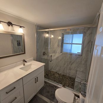 CRC Builders - a bathroom with a toilet, sink, and shower - General Contractors Near Me - Oldsmar, Florida