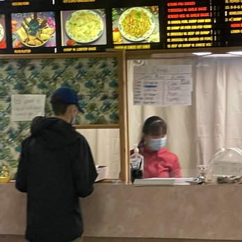 China King - a man and a child at a restaurant counter - Chinese Near Me - Fairport, New York