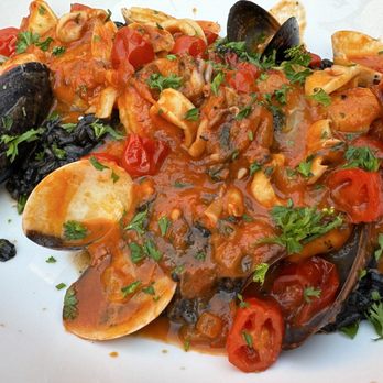 Fiamma Centro - Risotto Pescatore Al Nero (Arborio Rice, clams, mussels, shrimp, calamari, scallops, black squid ink sauce, cherry tomato) - Pizza Near Me - Rochester, New York Fiamma Centro - Risotto Pescatore Al Nero (Arborio Rice, clams, mussels, shrimp, calamari, scallops, black squid ink sauce, cherry tomato) - Pizza Near Me - Rochester, New York